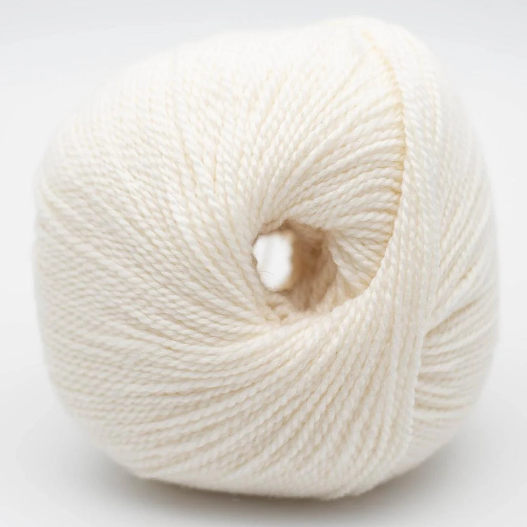 Wollknäuel in weiß mit feiner Strickgarn-Textur und kleiner Öffnung in der Mitte