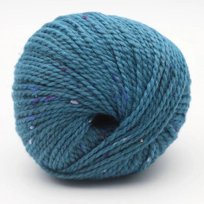 Garnknäuel in Blau mit kleinen Farbklecksen, gleichmäßige Wicklung und zentrales Loch