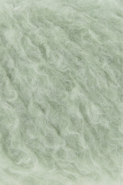 Piuma-Wollgarn in hellgrüner Flauschfaser-Textur, Nahaufnahme